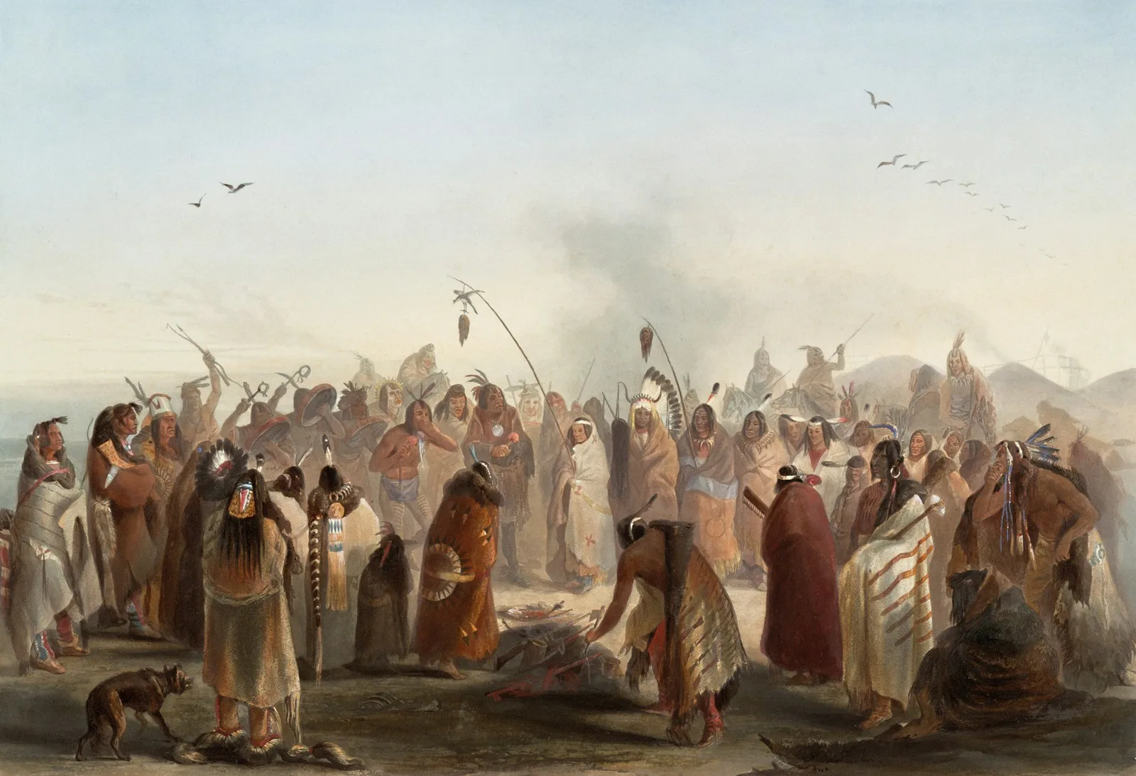 Indigenous people gather for a ceremony with smoke rising.