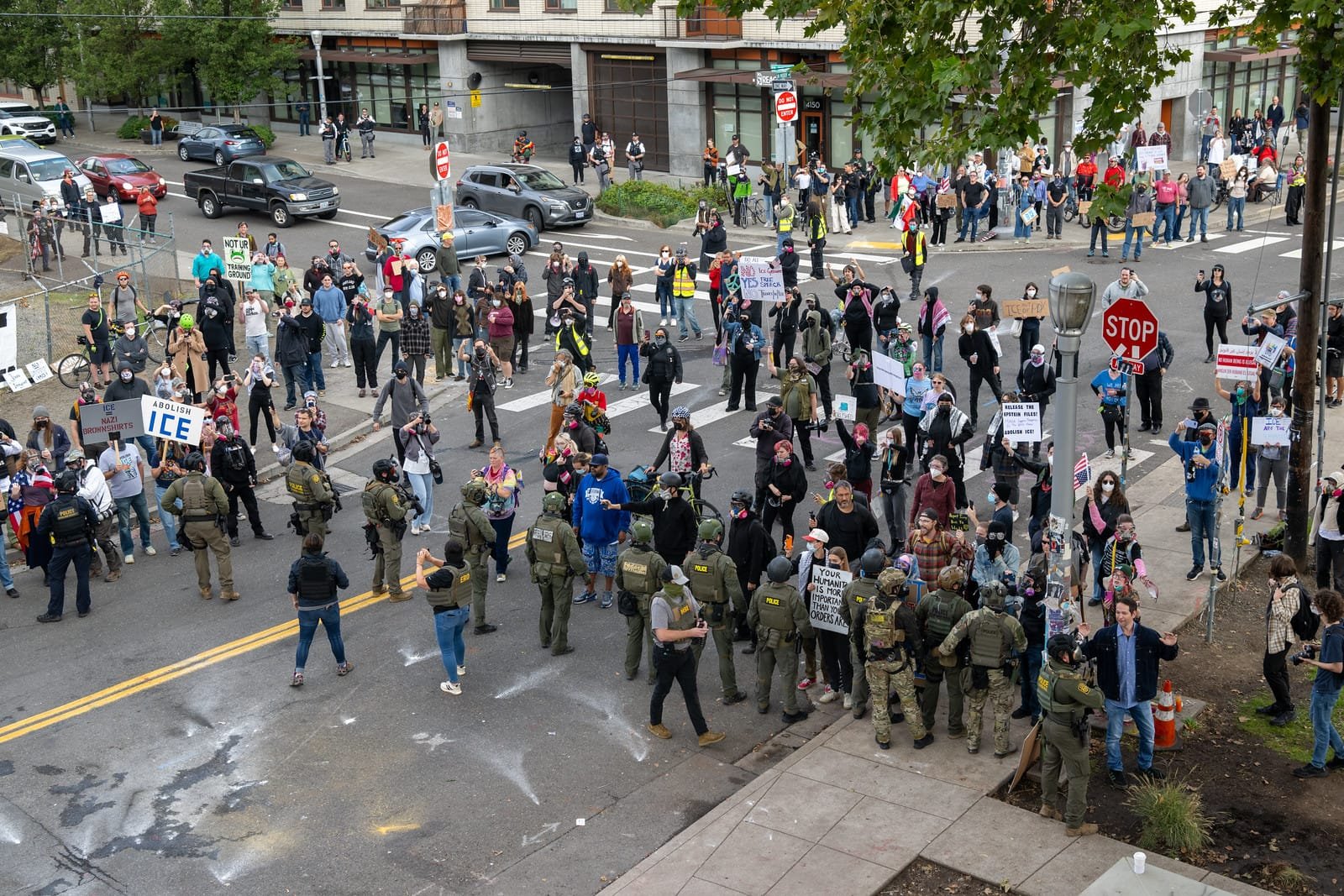 Protesters amass on the street as federal officers from the U.S. Bureau of Prisons, U.S. Customs and Border Protection, U.S. Border Patrol, Homeland Security Investigations and U.S. Immigration and Customs Enforcement provide security for the ICE facility in Portland, Oregon on October 4, 2025.