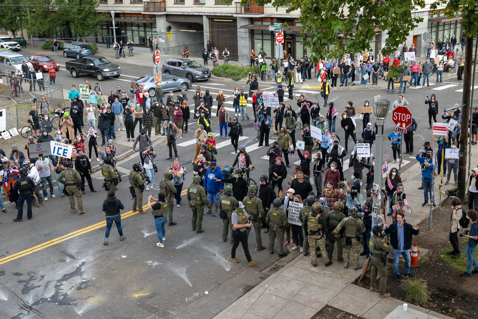 Protesters amass on the street as federal officers from the U.S. Bureau of Prisons, U.S. Customs and Border Protection, U.S. Border Patrol, Homeland Security Investigations and U.S. Immigration and Customs Enforcement provide security for the ICE facility in Portland, Oregon on October 4, 2025.